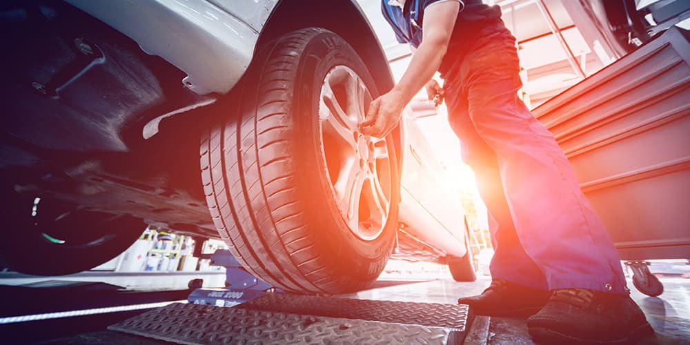 Photo of Mechanic fixing the tire of the car